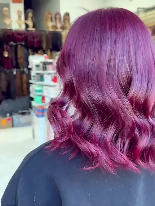 Shoulder-length violet hair in loose curls